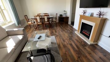 Apartment, Multiple Beds | Living area | Flat-screen TV, fireplace