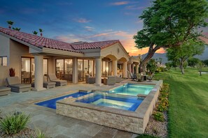 A modern house with a swimming pool, outdoor seating, and a well-maintained lawn. - Sensational 3 Bedroom 3.5 Bath Private Pool Home With Stunning Views (La Quinta)