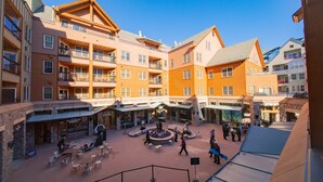 A courtyard with outdoor seating, a central fountain, and multi-story buildings with balconies. - Buffalo Lodge 8343 OFB (Keystone)