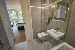 Bathtub, hair dryer, towels, shampoo
