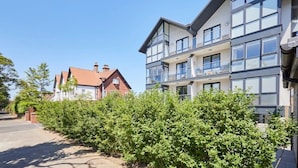 A modern two-story building with large windows and balconies, surrounded by greenery. - Host & Stay | Scarborough View Luxury Apartment (Scarborough)