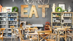 A café interior with wooden chairs, tables, and shelves stocked with items. - Views of the Gulf, Private Beach Access, & Bikes (Santa Rosa Beach)
