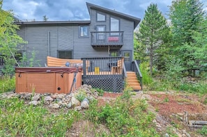 A modern two-story house with a deck and a hot tub in the front yard. - Hawn Drive 62 4 Bedroom Townhouse by RedAwning (Frisco)