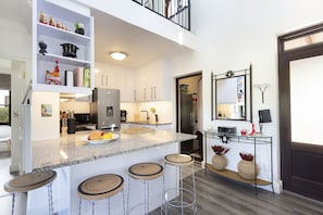 Enjoy cooking in this well-equipped kitchen with a spacious island, sink, and ample counter space.