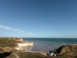 Paisaje costero con acantilados y una vista despejada del mar.