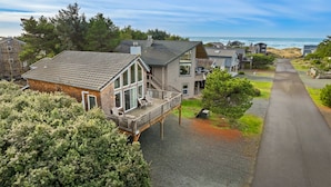 A coastal residential area with houses, a paved driveway, and a view of the ocean. - Stargazer-1/2 blk to the beach and golf course, ocean view from deck MCA#251 (Manzanita)