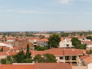 A residential area with red-tiled roofs, a mix of single and multi-story buildings, and some greenery.