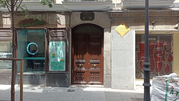 A building facade with a wooden double door, a green signboard, and a stone plaque. - Rooms for rent in Barrio Chueca - Madrid INF1F (Madrid)