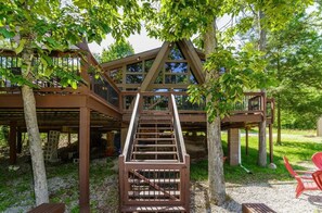 A wooden cabin with a staircase leading to a deck, surrounded by trees. - Cozy Chalet in the Woods
http://www.innsbrook-resort.com/ (Innsbrook)