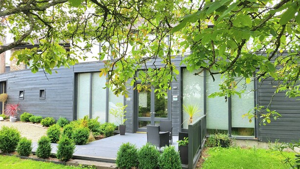 A modern house with a patio, small garden, and a view of the surrounding area. - Beautiful 2-bed Apartment Near Waterford City (Waterford)