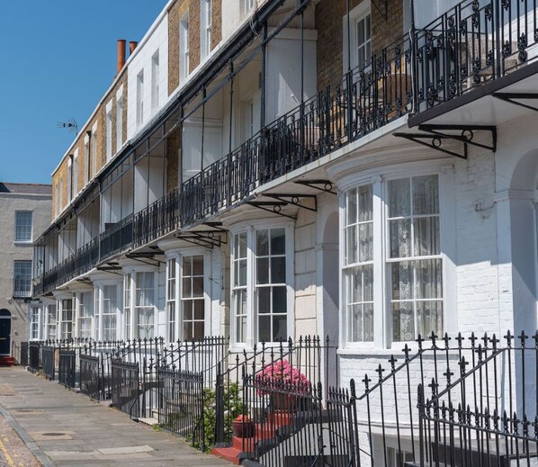 A row of white terraced houses with black iron railings and a clear blue sky. - Ramsgate | Elegant Georgian Home | Harbour | Beach (Kent)