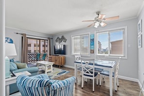 Relax in this open-plan living space with a dining area, sofa, and flat-screen TV.