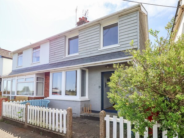 A two-story residential building with a white picket fence, a front porch, and a small garden area. - Long View (Reydon)
