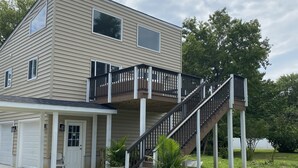 A two-story house with a front porch, a staircase, and a garage. - Bayou on the Bay (Stevensville)