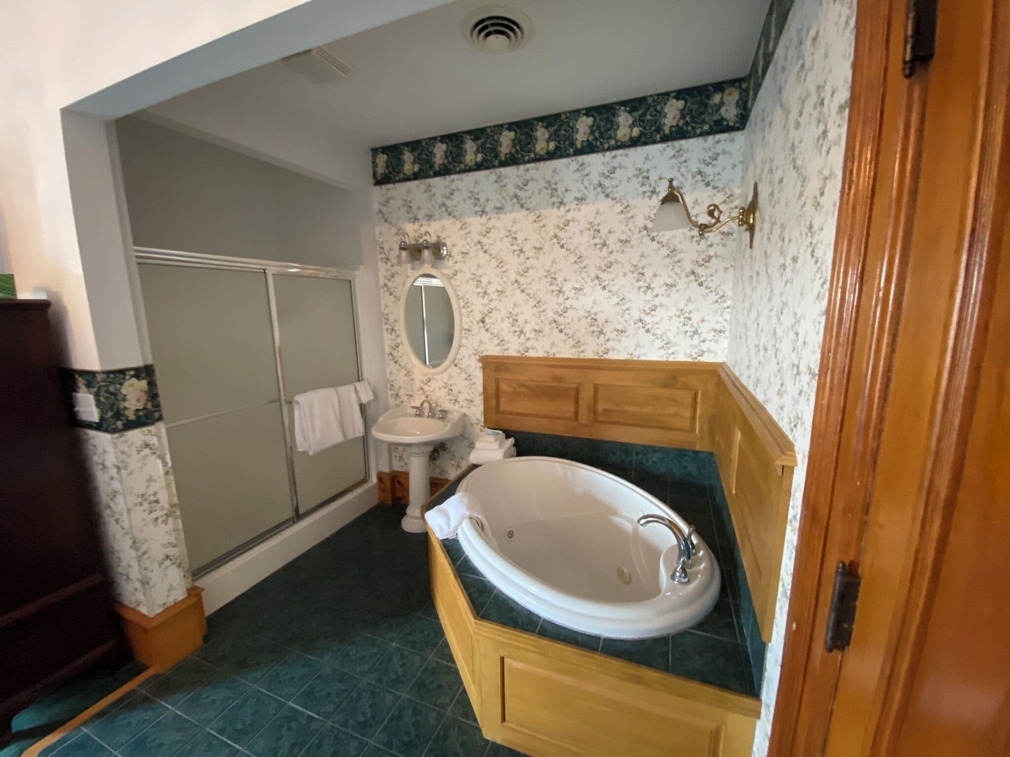 A bathroom with a shower, sink, and vanity.