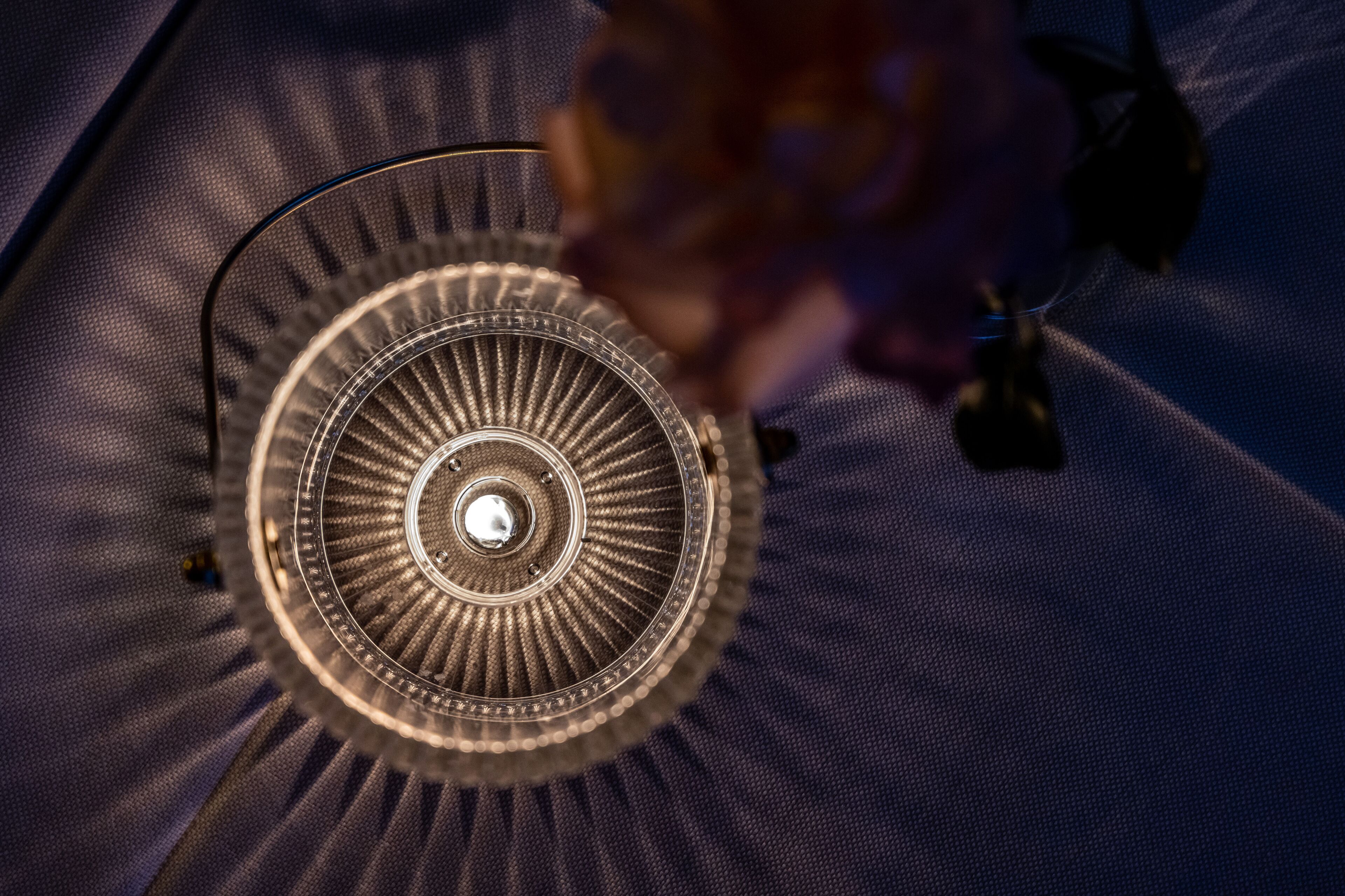 A close-up of a ceiling fan with a central light fixture.