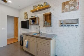 Enjoy cooking in this well-equipped kitchen with a central island, sink, and ample countertop space.