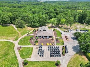 An aerial view of a building surrounded by greenery, with a parking lot in front. - #2400 Pointe - Studio Suite at Mariners SML (Huddleston)