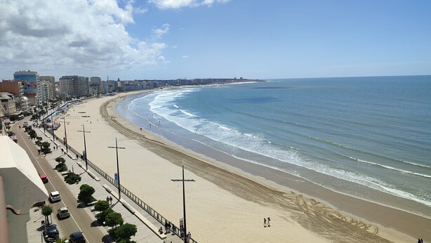 A coastal cityscape with a wide beach, a promenade, and high-rise buildings in the background. - La Maison du Verger - 13km from the beach (Sainte-Foy)