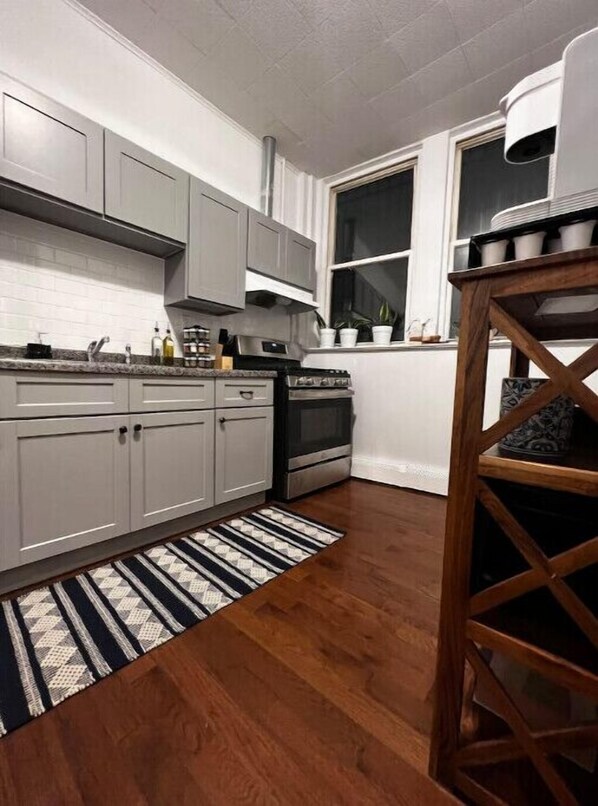 Enjoy cooking in this well-equipped kitchen with an oven and stainless steel range hood.