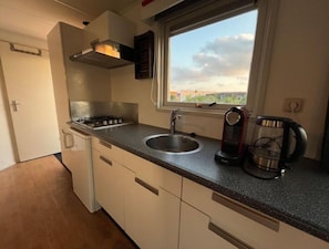 Fridge, microwave, stovetop, coffee/tea maker