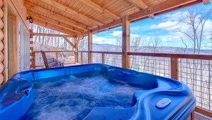A wooden cabin with a hot tub and a view of the mountains. - Lasting Impressions by Jackson Mountain Rentals (Gatlinburg)