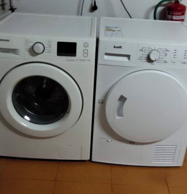 Two white front-loading washing machines side by side.