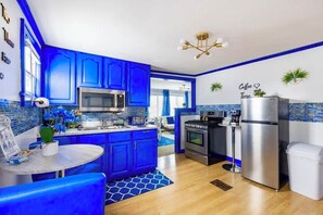Enjoy cooking in this well-lit kitchen with a central island and stainless steel appliances.