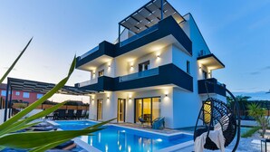 A modern two-story house with a swimming pool, outdoor seating, and a covered patio area. - Beach front home in Bibinje (Bibinje)