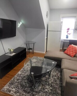 Relax in this stylish living room with a flat-screen TV, comfortable sofa, and convenient coffee table.