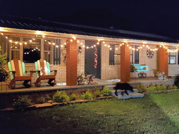 A house with a porch decorated with string lights, a brick exterior, and outdoor seating. - Rich Mountain Home Away -
Wifi, Forest trails for all ATV'S, horses and hiking! (Paris)