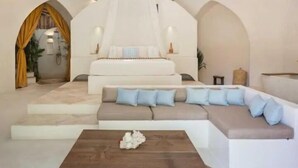 A modern living room with a large sofa, a coffee table, and a decorative canopy. - Villa Sanah (Tulum)