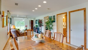 A dining area with a wooden table, chairs, and a bowl of fruits. There are potted plants and a ceiling fan. - Emory Vacation Rental w/ Lake Fork Boat Access! (Emory)