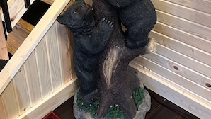En trætrap med en bjørneskulptur for neden.