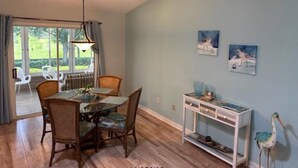 A dining area with a table and chairs, a hanging light fixture, and artwork on the wall. - Beautiful 3 bed / 2 bath home near Lake Sumter w/ cart, 2 bikes and wi-fi!   (The Villages)