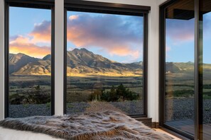 Enjoy breathtaking mountain views from the large window in this stylish room.
