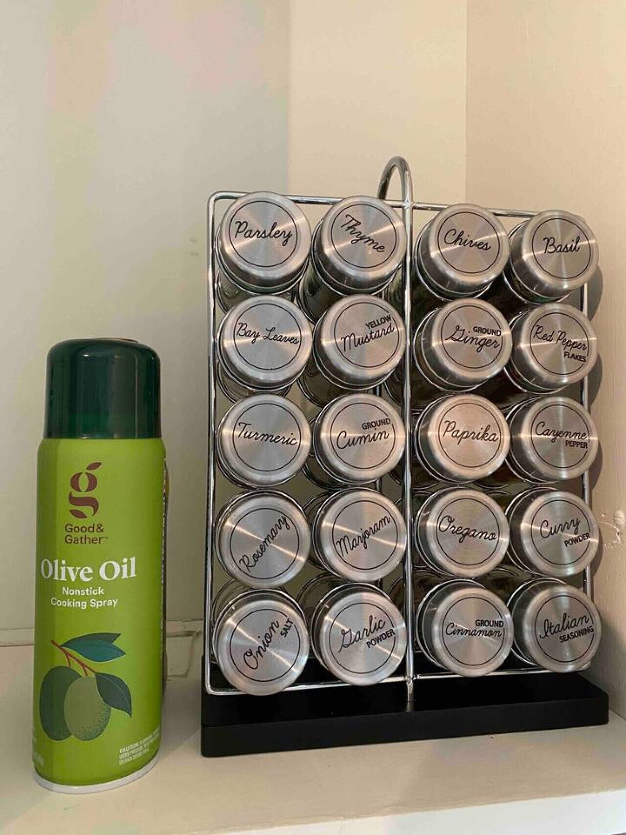 A rack of spice tins and a can of olive oil.