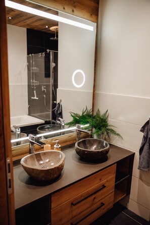 Bathtub, hair dryer, towels, toilet paper