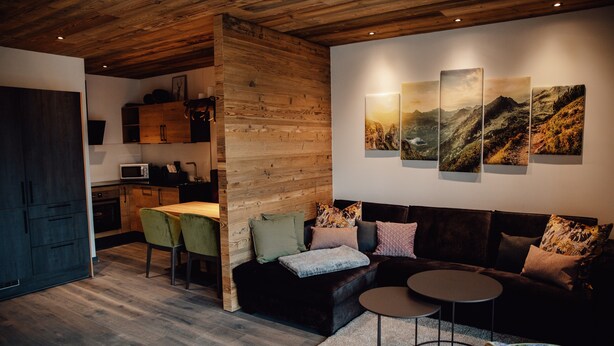 A modern interior with a wooden ceiling, a dining area with chairs, a sofa, and a coffee table. - Chalet 'Zillertal Juwel' with Mountain View, Balcony and Wi-Fi (Fügen)