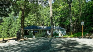 A cabin with a gravel driveway, surrounded by dense forest. - Cozy Muskoka cottage (Bracebridge)