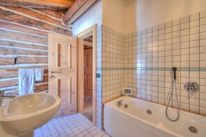 Bathtub, hair dryer, bidet, towels