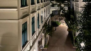 A building with a symmetrical facade, large windows, and a central courtyard with palm trees. - Minh Anh Hotel (Phu Quoc)