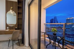 A modern interior with a dining area, a large window, and a cityscape view. - M9 Kirirom Hotel  (Phnom Penh)