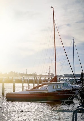 A dock with a boat moored at the pier.