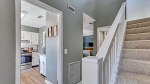 A kitchen with white cabinets, a built-in oven, and a microwave. - GATA 2 -The Rustic Suite - Close to GSU (Statesboro)