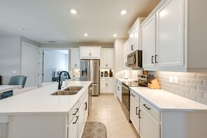 Enjoy cooking in this well-equipped kitchen with a sink, refrigerator, and oven.