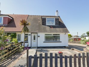 A single-story house with a white exterior, a dark roof, and a small front porch. - 22 Turnberry Road (Girvan)