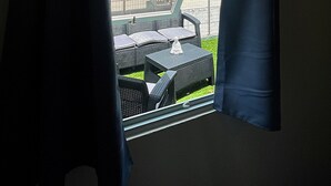 A room with a large window overlooking a building with a staircase and a fenced outdoor area. - Historic Ocean Park Near Beach Water Reserve Fiber Internet Fast WiFi (San Juan)