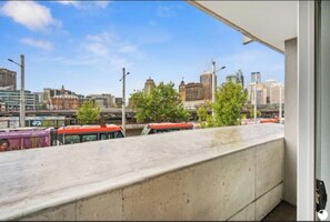 Enjoy breathtaking views of the city from this expansive balcony.