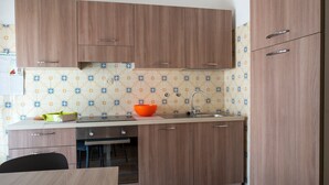 A kitchen with wooden cabinets, a sink, and a countertop. - Apartment "Semia" with Mountain View, Balcony & Wi-Fi (Vinadio)